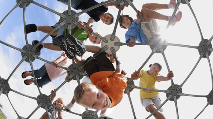 Happy children playing on a climbing structure before everything fell apart forever